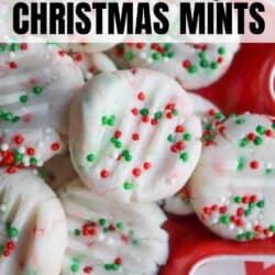 Close-up of round cream cheese mints topped with red, green, and white sprinkles. Theyre arranged on a red plate. Text at the top reads cream cheese Christmas mints and homemadeheather.com is at the bottom.