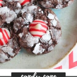 A delicious plate of candy cane brownie blossoms topped with red and white striped Hershey's Kisses, dusted with powdered sugar. Text below reads homemadeheather.com.