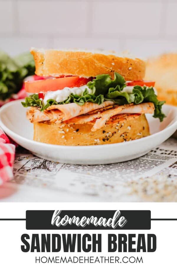 A delicious sandwich on homemade bread, stacked with turkey slices, lettuce, tomato, and a dollop of mayonnaise on a white plate. The background features fresh ingredients, and the text homemade sandwich bread along with a website URL is displayed.