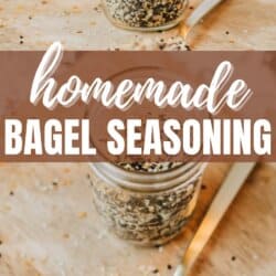 Jar of homemade bagel seasoning on a wooden board with a spoon next to it. The text homemade bagel seasoning is prominently displayed.