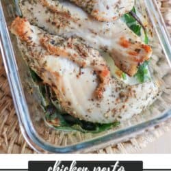 Grilled chicken pieces seasoned with herbs in a glass dish, resting on spinach leaves. The image features a chicken pesto meal prep label and a website mention: homemadeheather.com.