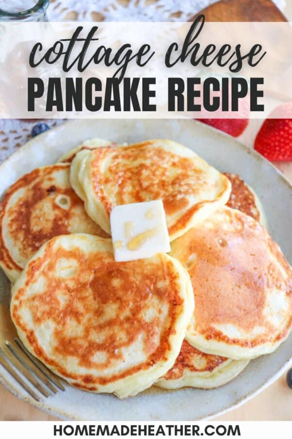 Plate of golden-brown pancakes topped with a pat of butter and honey, accompanied by a fork. The text cottage cheese pancake recipe is at the top, with the website homemadeheather.com at the bottom.