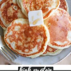 A plate of golden-brown pancakes topped with a pat of butter and drizzled with syrup. A fork rests on the side. The text reads, High Protein Pancake Recipe, homemadeheather.com.
