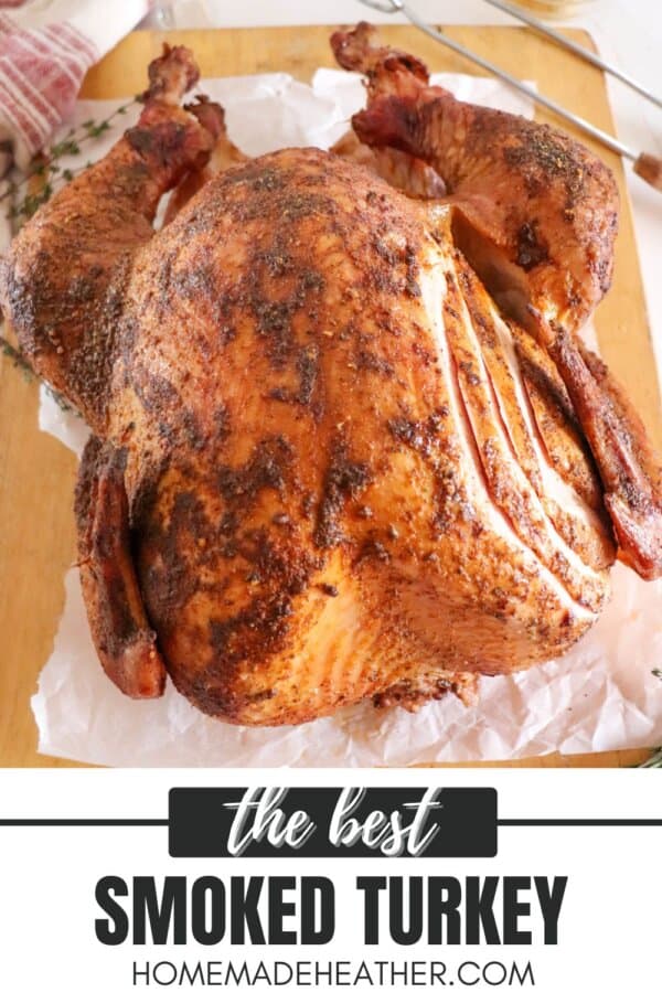 A whole smoked turkey with a crispy, golden-brown skin is displayed on a parchment-lined board. The turkey is seasoned and has a few cuts on its skin. Below, the text reads: the best SMOKED TURKEY homemadeheather.com.