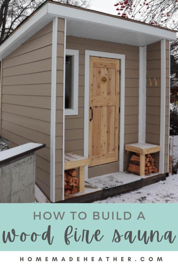 A small wood fire sauna with a light brown exterior and a wooden door invites warmth. Neatly stacked firewood flanks the entrance, while snow carpets the ground and trees stand nearby. Text overlay reads, DIY: How to build a wood fire sauna.