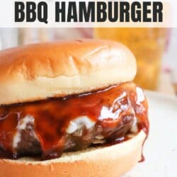 A juicy BBQ hamburger with melted cheese and barbecue sauce on a bun, displayed on a plate. The image includes text: the best BBQ hamburger and homemadeheather.com at the bottom.