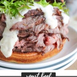 A roast beef sandwich with slices of beef, leafy lettuce, and creamy sauce on a bun, placed on a white plate. The text reads roast beef SANDWICHES with a website link to homemadeheather.com.