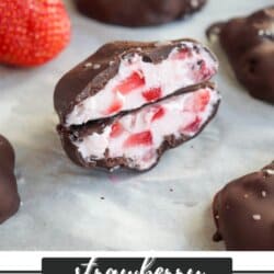 Close-up of chocolate-coated strawberry yogurt clusters on parchment paper, with one cut open showing creamy yogurt and strawberry pieces inside. A fresh strawberry and more clusters are in the background. Text at bottom reads strawberry yogurt clusters.