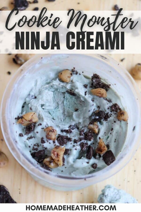 A bowl of Cookie Monster ice cream made with the Ninja Creami, featuring blue ice cream mixed with chocolate chunks and cookie pieces. The background has scattered cookie bits. Text on top reads Cookie Monster Ninja Creami.