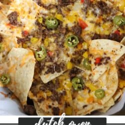 A close-up of nachos topped with melted cheese, ground beef, sliced jalapeรฑos, and red and yellow peppers. Text overlay reads Dutch Oven Nachos Recipe homemadeheather.com.