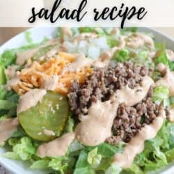 A salad in a bowl featuring lettuce, ground beef, shredded cheese, pickles, diced onions, and a creamy dressing drizzled on top. Text overlay reads, Viral Big Mac salad recipe.