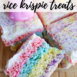 Colorful Rice Krispie treats topped with white frosting and pastel sprinkles, displayed on a wooden surface. Some treats are stacked, showing layers of pink, blue, yellow, and purple. Text reads Easter Peeps Rice Krispie Treats and homemadeheather.com.
