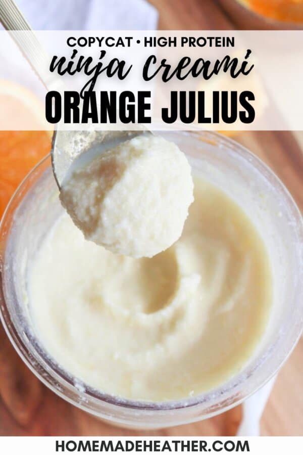A close-up of a creamy, orange-colored dessert in a blender cup. A spoon holds a scoop above the cup. Text on the image reads Copycat High Protein Ninja Creami Orange Julius Recipe and homemadeheather.com.