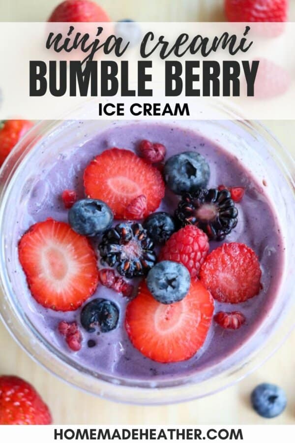 A bowl of purple ice cream topped with fresh strawberries, raspberries, blueberries, and blackberries. The text reads Ninja Creami Bumble Berry Ice Cream. The website address at the bottom is homemadeheather.com.