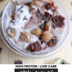 A bowl of creamy ice cream with chocolate chunks, brownie pieces, and small cookie dough bites, served with a spoon. The text reads, High Protein • Low Carb, Ninja Creami, Half Baked Ice Cream, Homemade Heather.