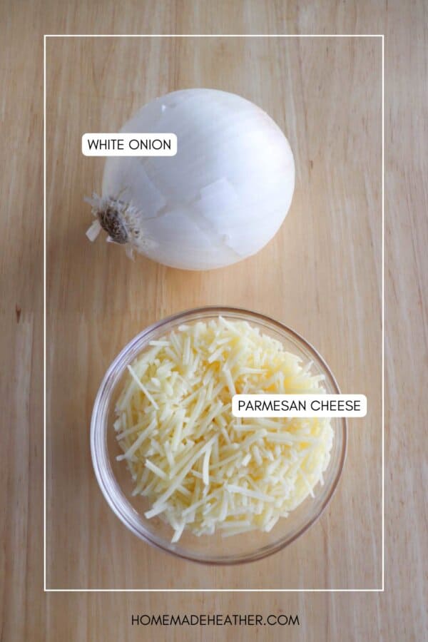 A whole white onion and a bowl of shredded Parmesan cheese on a wooden surface. Labels identify each ingredient.