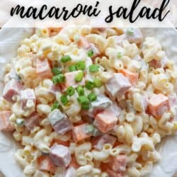 A white plate filled with creamy macaroni salad featuring cubes of ham and cheese, topped with chopped green onions. The text Ham & Cheese Macaroni Salad is displayed at the top, along with the URL homemademadeheather.com.