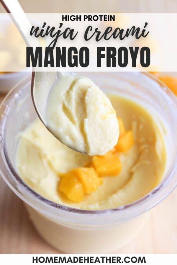 A spoon lifts a smooth, creamy mango frozen yogurt from a container, garnished with diced mango pieces. Text reads High Protein Ninja Creami Mango Froyo.