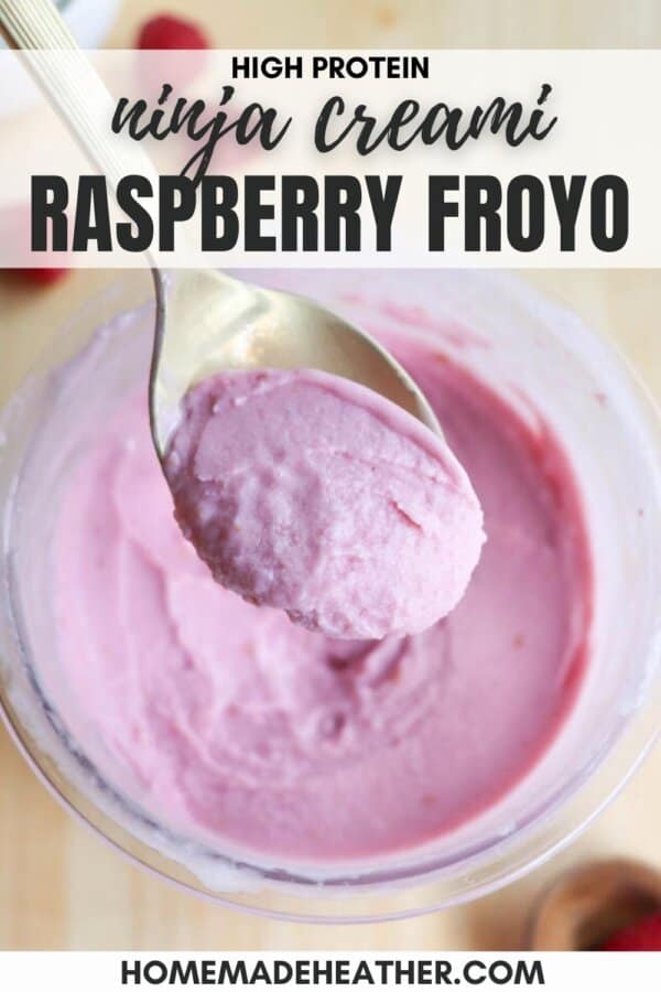 A spoonful of pink raspberry frozen yogurt is held above a container filled with more yogurt. The text above reads High Protein Ninja Creami Raspberry Froyo, and below reads homemadeheather.com.