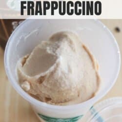 A close-up of a creamy frappuccino in a clear cup with a green straw and Starbucks logo. The text reads Starbucks Ninja Creami Frappuccino and homemadeheather.com. A coffee container is partially visible in the background.