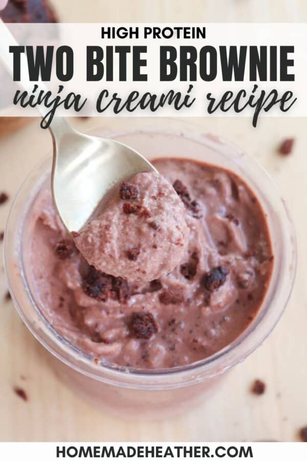 A spoonful of a creamy, chocolatey mixture with brownie chunks, labeled High Protein Two Bite Brownie Ninja Creami Recipe, in a clear bowl. Background shows a piece of brownie. Website homemadeheather.com is noted at the bottom.
