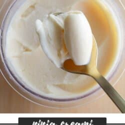 A spoon scoops creamy eggnog ice cream from a clear container, with text below reading “Ninja Creami Eggnog Ice Cream homemadeheather.com.”.