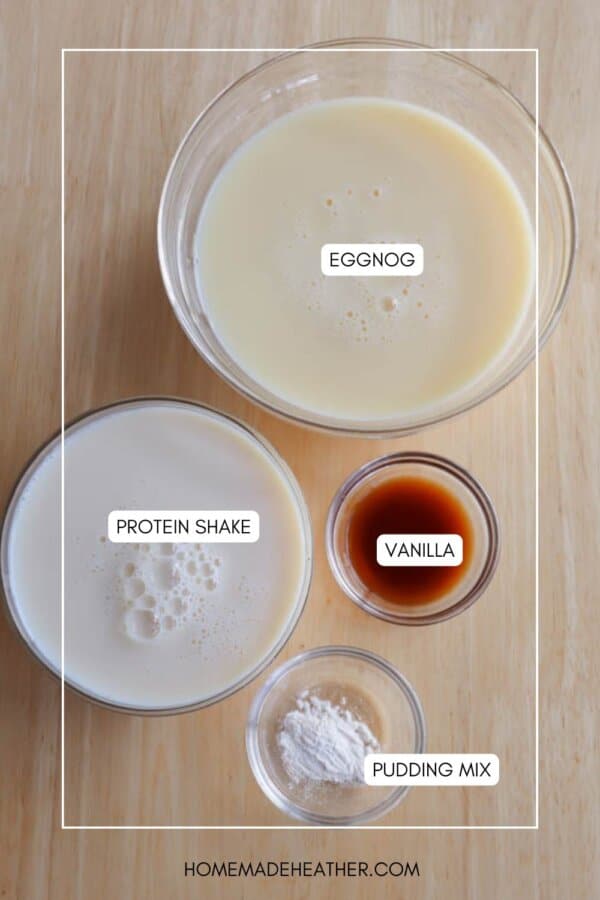 Four bowls on a wooden surface contain eggnog, protein shake, vanilla extract, and pudding mix, each labeled with text inside or near the bowls.