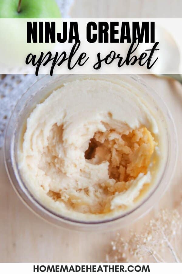 Top view of creamy apple sorbet in a container, with a smooth texture and swirls. Text on the image reads Ninja Creami Apple Sorbet on top and homemadeheather.com at the bottom. An apple and dried flowers are blurred in the background.