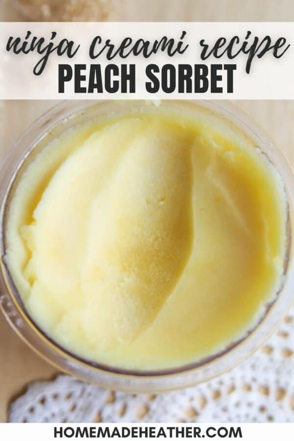 Close-up of a bowl filled with creamy peach sorbet. Text overlay reads: ninja creami recipe - PEACH SORBET. The bottom of the image shows part of a doily and the words homemadeheather.com.