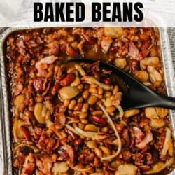 A tray of bar-b-que baked beans topped with pieces of bacon, with a black serving spoon resting inside. The text above reads BAR-B-QUE BAKED BEANS and homemadeheather.com is at the bottom.
