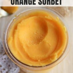 Close-up of a glass container filled with smooth orange sorbet on a light textured surface. A doily is partially visible under the container. Text at the top reads Ninja Creami Recipe and Orange Sorbet. At the bottom is homemadeheather.com.
