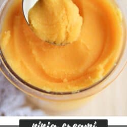 A close-up of a glass bowl filled with orange sorbet. A spoon is scooping a portion from the top. Text at the bottom reads ninja creami ORANGE SORBET homemadheather.com.