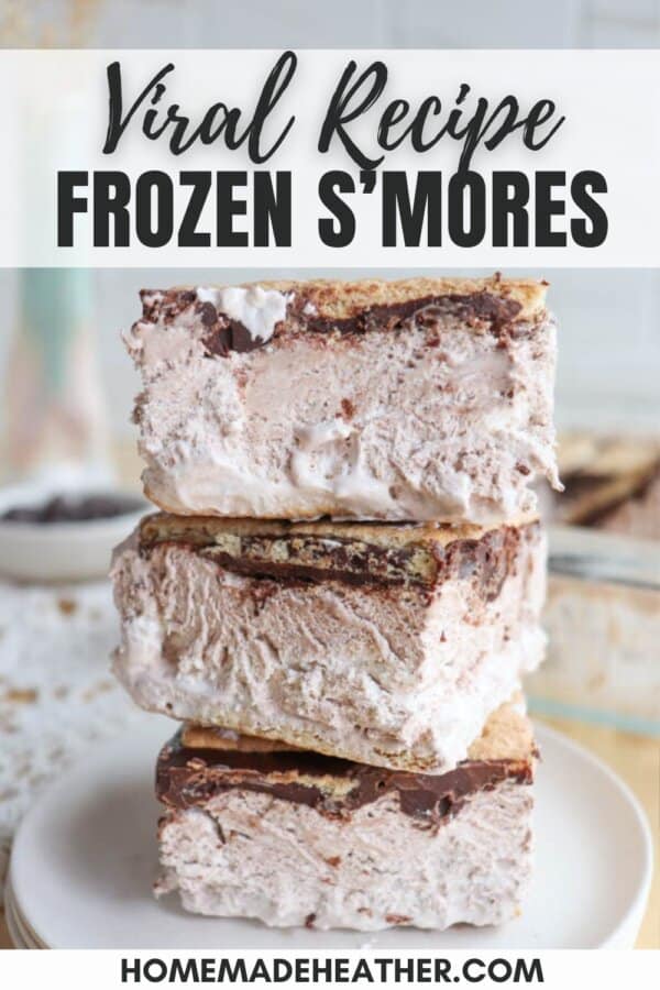 A stack of three frozen smores with layers of marshmallow, chocolate, and graham crackers. The top smore is slightly tilted. The text on the image reads Viral Recipe Frozen Smores and homemadeheather.com.