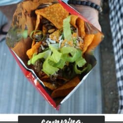 A hand holds an open Doritos bag filled with ground beef, cheese, lettuce, and jalapeños for the perfect Walking Tacos Recipe. Text below reads: “camping WALKING TACOS HOMEMADEHEATHER.COM”.
