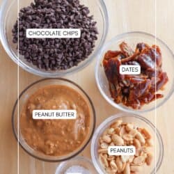 Four bowls containing chocolate chips, dates, peanut butter, and peanuts are labeled. A small pile of salt is nearby. The background is a wooden surface. The text reads homemadeheather.com.
