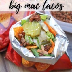 A bag of Doritos opened and filled with taco ingredients including ground beef, lettuce, cheese, pickles, and sauce. Text on the image reads “WALKING big mac tacos” and “homemadeheather.com” at the bottom.