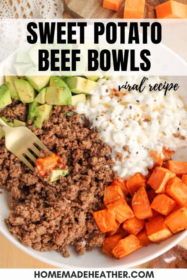 A plate filled with ground beef, diced avocados, cottage cheese, and roasted sweet potato cubes. A fork holds a piece of sweet potato. Text overlay reads Sweet Potato Beef Bowls - viral recipe and homemadeheather.com at the bottom.