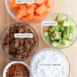 Top view of five bowls containing different ingredients on a wooden surface. The bowls are labeled: sweet potato, avocado, ground beef, cottage cheese, and hot honey. Website text reads homemadeheather.com at the bottom.