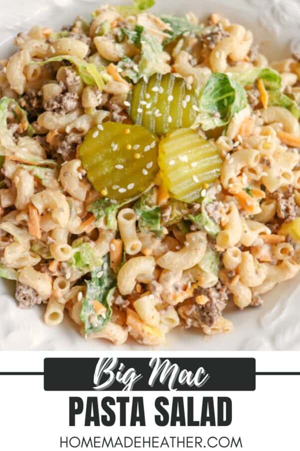 A plate of Big Mac pasta salad with macaroni, ground beef, lettuce, shredded cheese, pickles, and sesame seeds, with a label reading Big Mac Pasta Salad homemadHeather.com.