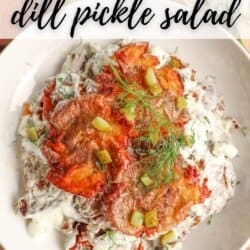 A bowl of smashed potato salad topped with dill, chopped pickles, and a creamy dressing. Text reads “Smashed Potato dill pickle salad” and “homemadeheather.com” at the bottom.