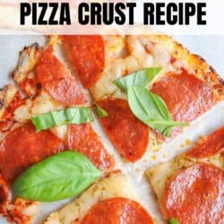 Close-up of a pepperoni pizza with a cottage cheese crust, topped with fresh basil leaves. Text on image reads Cottage Cheese Pizza Crust Recipe and homemadeheather.com at the bottom.