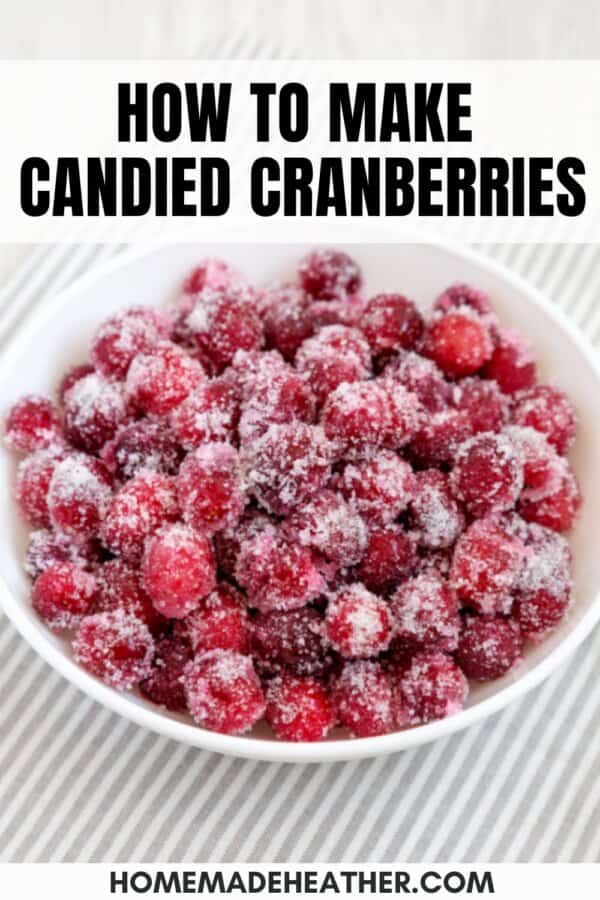 A white bowl filled with sugar-coated candied cranberries sits on a striped cloth. Text above reads How to make candied cranberries, and homemadeheather.com appears at the bottom.