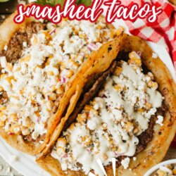 Two tacos filled with smashed street corn, topped with crumbled cheese and creamy sauce, on a plate with a red and white checkered napkin. Text on the image reads Street Corn Smashed Tacos and The Best Smashup!.