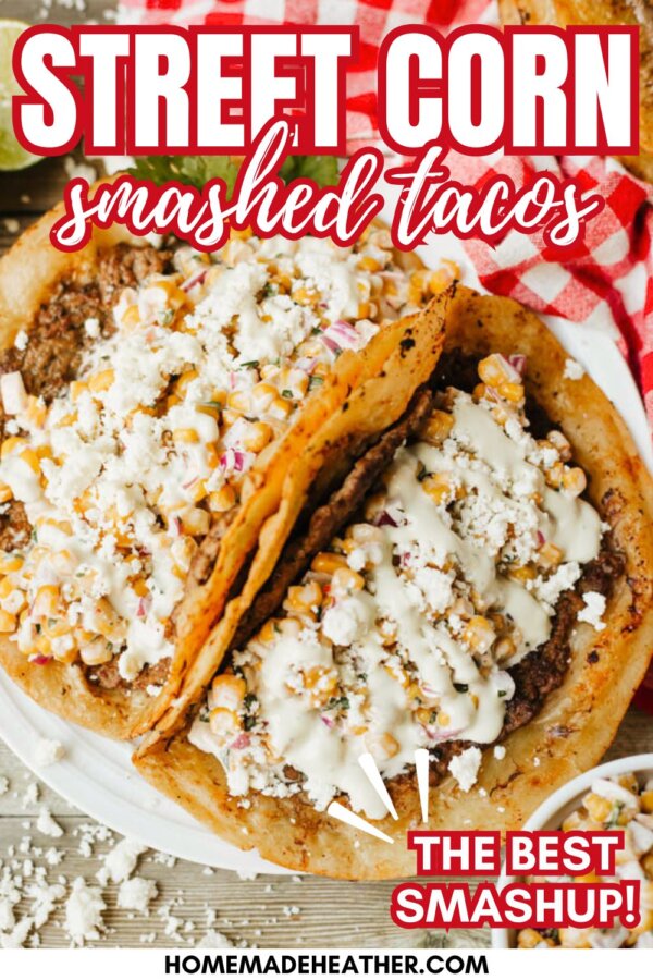 Two tacos filled with smashed street corn, topped with crumbled cheese and creamy sauce, on a plate with a red and white checkered napkin. Text on the image reads Street Corn Smashed Tacos and The Best Smashup!.