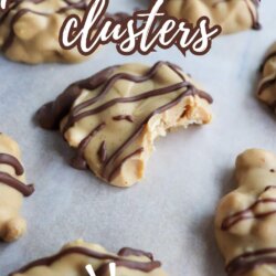 Close-up of peanut butter clusters drizzled with chocolate, with one cluster showing a bite taken out. Text reads โpeanut butter clusters, 5-ingredientโ on a parchment-lined surface.