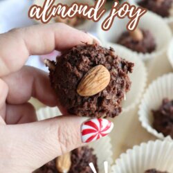 A hand holding a chocolate coconut ball topped with an almond. More treats are in white paper liners below. Text reads: Crockpot Almond Joy and So good! Website: homemadeheather.com.
