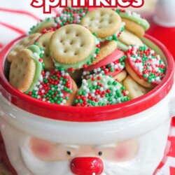 A festive bowl shaped like Santaโs face is filled with mini Ritz cracker sandwiches coated in white chocolate and decorated with red, green, and white sprinkles. Text reads: mini ritz sprinkles and EASY TREAT.