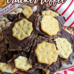A festive plate of Christmas Ritz cracker toffee topped with chocolate and Ritz crackers, with a red and white striped cloth in the background and text that reads christmas ritz cracker toffeeโSO FESTIVE!.