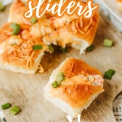 Close-up of crab rangoon sliders topped with chopped green onions on a wooden board, with one slider pulled apart. Text reads Crab Rangoon Sliders and So Good! at the bottom.