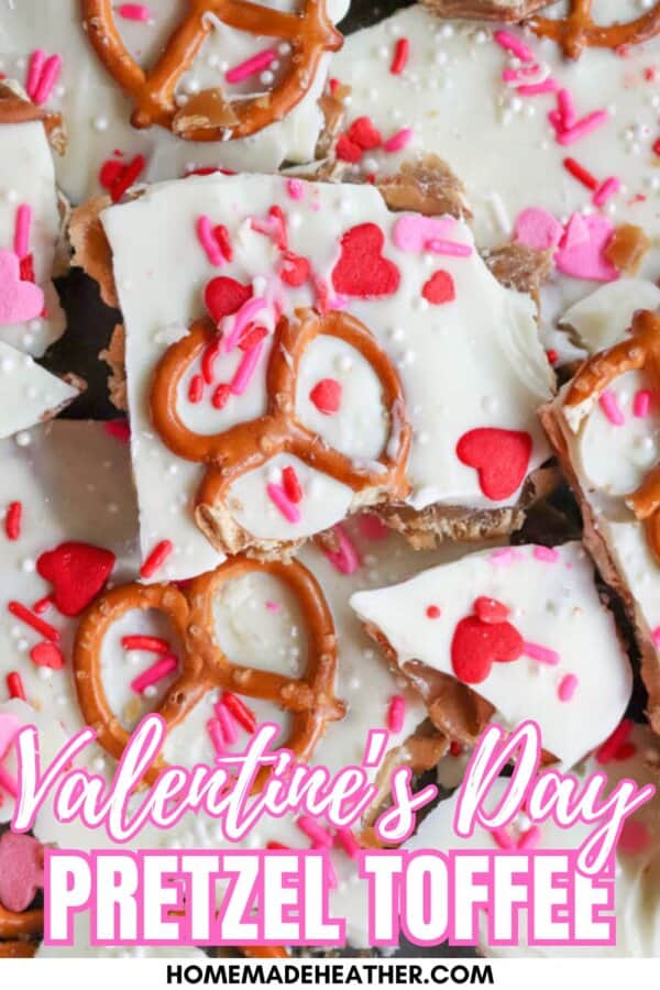 Close-up of Valentineโs Day pretzel toffee topped with white chocolate, pretzels, pink and red heart sprinkles, and confetti sprinkles. Text reads Valentineโs Day Pretzel Toffee homemadetheather.com.